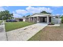 Attractive brick home with a covered porch and driveway at 2205 9Th Ne Ct, Winter Haven, FL 33881