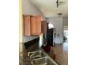 Kitchen with dark countertops and wood cabinets needing updating at 417 Bay Leaf Dr, Kissimmee, FL 34759