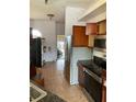View of kitchen with stainless steel appliances and wood cabinets at 417 Bay Leaf Dr, Kissimmee, FL 34759