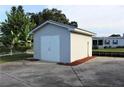 Detached storage shed with double doors in backyard at 535 Minnow Ct, Kenansville, FL 34739
