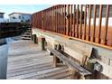 Wooden deck and dock with bench overlooking the water at 535 Minnow Ct, Kenansville, FL 34739