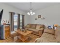 Living room featuring hardwood floors, comfy couch, and a coffee table at 1801 Stargazer Trl, Kissimmee, FL 34758