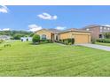 One-story house with a large yard, driveway, and two-car garage at 1801 Stargazer Trl, Kissimmee, FL 34758
