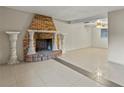 Spacious living room featuring a brick fireplace and tile floors at 2800 S Park Ave, Sanford, FL 32773