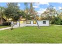 Ranch-style home with white exterior, black trim, and a green lawn at 2800 S Park Ave, Sanford, FL 32773