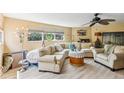 Spacious living room featuring a curved sofa and comfortable armchairs at 201 N Cortez Ave, Winter Springs, FL 32708