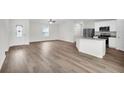 Open living room with wood-look floors and kitchen island at 255 Marion Oaks Mnr, Ocala, FL 34473