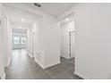 Bright hallway with tile floors and doors to other rooms at 1122 James Paul Rd, Davenport, FL 33837