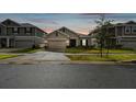 Two-story house exterior at dusk with a two-car garage at 1122 James Paul Rd, Davenport, FL 33837