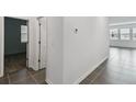 Clean hallway with tile floors and doors leading to bedrooms at 1122 James Paul Rd, Davenport, FL 33837