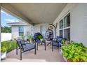 Relaxing covered patio with outdoor seating and lush greenery at 4448 Nw 2Nd Ct, Ocala, FL 34475