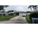 Two-story house with a spacious lawn and attached garage at 555 Alachua Dr, Winter Haven, FL 33884