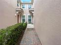 Brick paved walkway between townhomes, lush landscaping at 8311 Foster Dr, Davenport, FL 33896