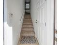 Interior entry with carpeted stairs and door at 8311 Foster Dr, Davenport, FL 33896