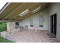 Inviting front patio with brick flooring, fountain, and seating area at 1889 Seclusion Dr, Port Orange, FL 32128