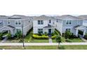 Two-story house with white and gray siding, surrounded by other homes at 14234 Lanikai Beach Dr, Orlando, FL 32827