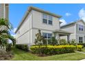Two-story house with gray siding and landscaping, in a neighborhood at 14234 Lanikai Beach Dr, Orlando, FL 32827
