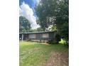Side view of a charming ranch house with landscaping and a green lawn at 118 5Th Jpv St, Winter Haven, FL 33880