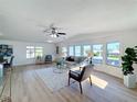 Open living area with large windows, hardwood floors, and comfortable seating at 1622 Tally Ho Dr, Lakeland, FL 33810