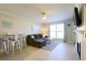 Open living room with sectional sofa and adjacent dining area at 2128 S Atlantic Ave # 2128, New Smyrna Beach, FL 32169