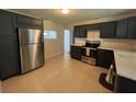 Modern kitchen with dark cabinets and stainless steel appliances at 1546 Daytona Ave, Daytona Beach, FL 32117