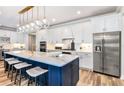 Modern kitchen with blue island, white cabinets, and quartz countertops at 4397 Sw 84Th Street Rd, Ocala, FL 34476