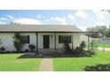 Front view of a charming white brick home at 3225 Oakland N Rd, Lakeland, FL 33801