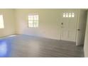 Bright living room with gray laminate floors at 3225 Oakland N Rd, Lakeland, FL 33801