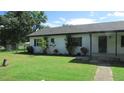 Side view of a white brick ranch house at 3225 Oakland N Rd, Lakeland, FL 33801