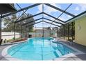 Inviting kidney-shaped pool with a screened enclosure and comfortable seating area at 105 Hainesport Dr, Lake Alfred, FL 33850