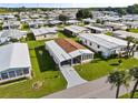 Aerial view of a manufactured home community showing a single-wide home with a carport at 6505 Raintree Ne Ln, Winter Haven, FL 33881