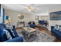 Spacious living room featuring plush blue sofas and a large rug at 5310 Verana Ct, Lakeland, FL 33813