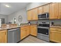 Modern kitchen featuring stainless steel appliances and light wood cabinets at 3050 Pirates Retreat Ct # 502, Kissimmee, FL 34747
