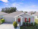 One-story home with gray siding and red shutters at 584 S Andrea Cir, Haines City, FL 33844