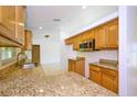 Kitchen with wood cabinets, granite countertops, and stainless steel appliances at 6556 Red Grange Blvd, Indian Lake Estates, FL 33855