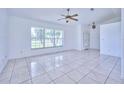 Bright living room with tile floors and large windows at 6556 Red Grange Blvd, Indian Lake Estates, FL 33855