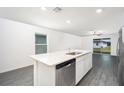 Open concept kitchen with stainless steel appliances, granite countertops and island at 3816 Corsican Pl, Lake Alfred, FL 33850