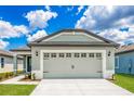 Newly constructed home with a two-car garage, attractive exterior, and a well-maintained lawn at 3816 Corsican Pl, Lake Alfred, FL 33850