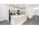 Modern kitchen boasts stainless steel appliances, granite countertops, and an island at 3816 Corsican Pl, Lake Alfred, FL 33850
