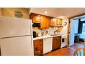 Cozy kitchen with wood cabinets and appliances at 3200 River Ranch Blvd # 160, River Ranch, FL 33867