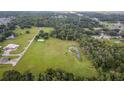 Aerial view of property with large lot, pond, and nearby buildings at 1440 Duff Rd, Lakeland, FL 33810