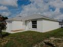 Newly constructed home with a white exterior and a two-car garage at 1138 Avenue E, Haines City, FL 33844