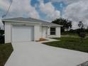 Newly constructed home with a white exterior and a two-car garage at 1138 Avenue E, Haines City, FL 33844