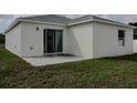 Newly constructed home with a white exterior and a patio at 1138 Avenue E, Haines City, FL 33844