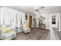 Bright living room with hardwood floors, two armchairs, and a decorative console table at 323 Nw 25Th St, Ocala, FL 34475