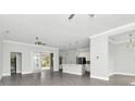 Open living room with gray tile floors and a kitchen island visible at 19073 Sabal St, Orlando, FL 32833