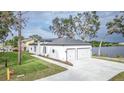 House exterior with a two car garage and waterfront view at 225 Diesel Rd, Mulberry, FL 33860