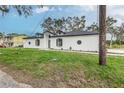 Modern home exterior with gray door and black shutters at 225 Diesel Rd, Mulberry, FL 33860