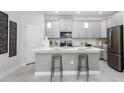 Modern kitchen with gray cabinets and island at 5271 Dagenham Dr, Davenport, FL 33837