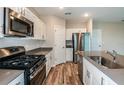 Modern kitchen with stainless steel appliances and an island at 3728 Dusty Miller Pl, Lake Hamilton, FL 33851